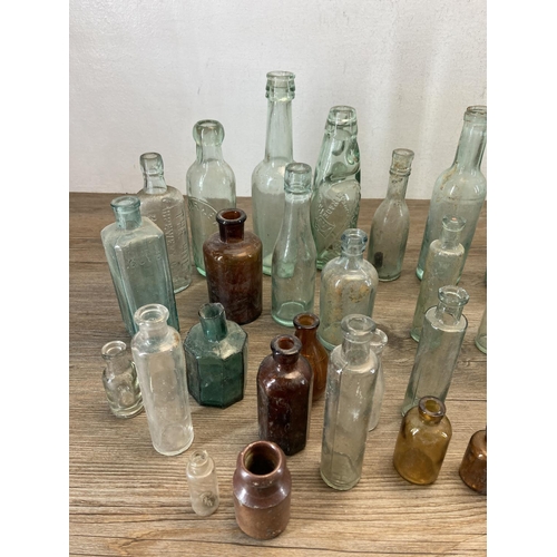 332 - A collection of early 20th century glass and stoneware bottles