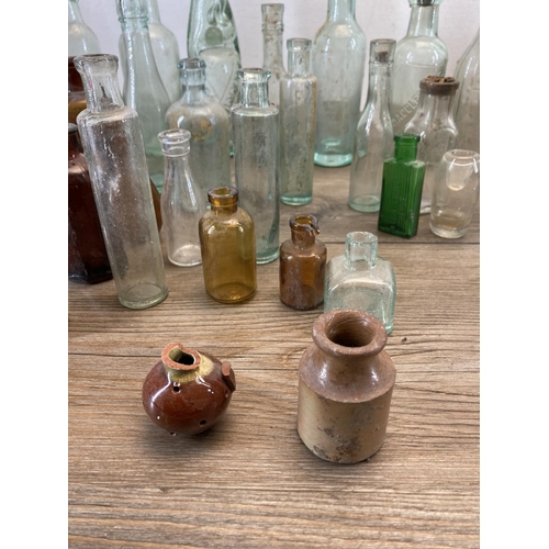 332 - A collection of early 20th century glass and stoneware bottles