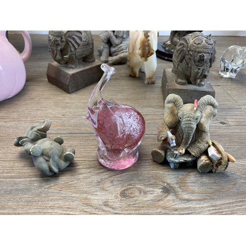 334 - Twenty elephant figurines to include resin, Langham Glass, onyx, carved teak etc. - largest approx. ... 