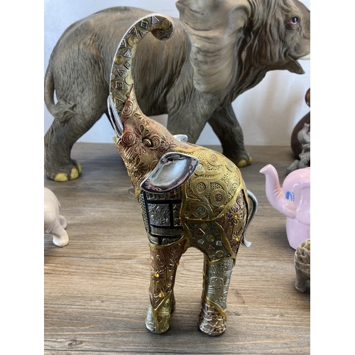 334 - Twenty elephant figurines to include resin, Langham Glass, onyx, carved teak etc. - largest approx. ... 