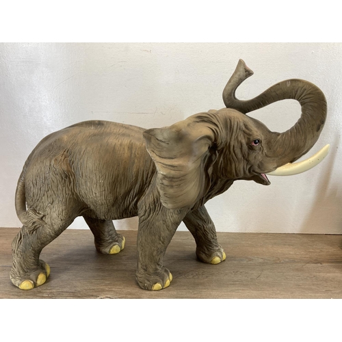 334 - Twenty elephant figurines to include resin, Langham Glass, onyx, carved teak etc. - largest approx. ... 