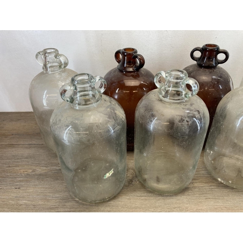 339 - Nine glass demijohns - approx. 43cm high