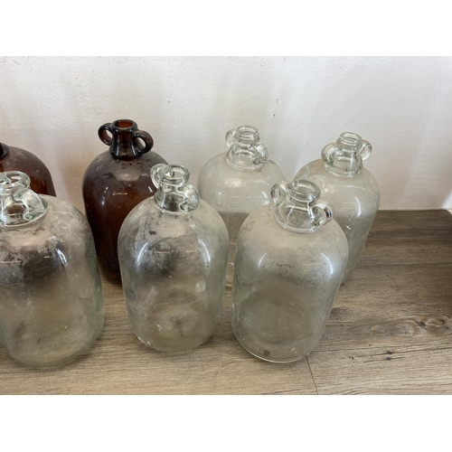 339 - Nine glass demijohns - approx. 43cm high