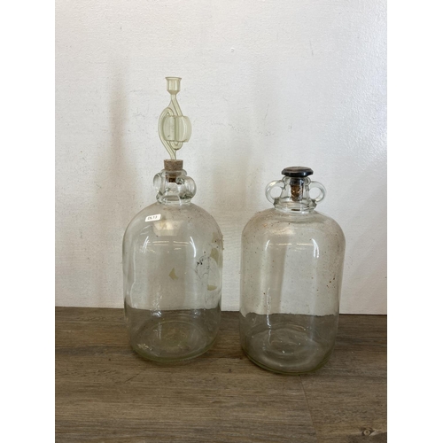 366 - A collection of glass bottles and demijohns together with wood and metal wine press - approx. 48cm h... 