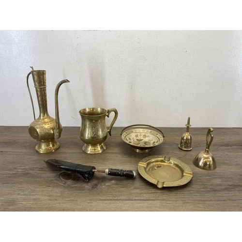 374 - A collection of brassware to include candlesticks, ashtray, clocks etc.