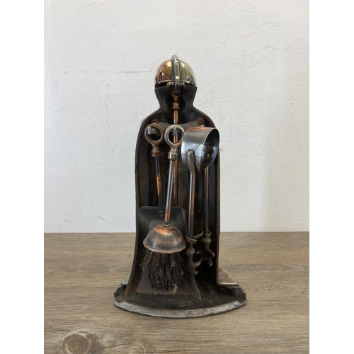 377 - A lustre finish cast iron knight fire side companion set - approx. 37cm high