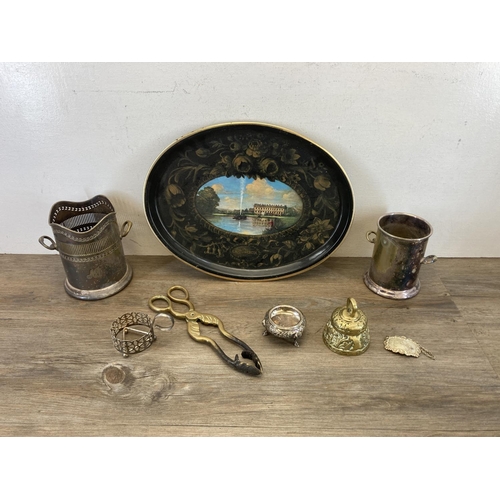 381A - A collection of metalware to include brass candlesticks, silver plated oval trays etc.