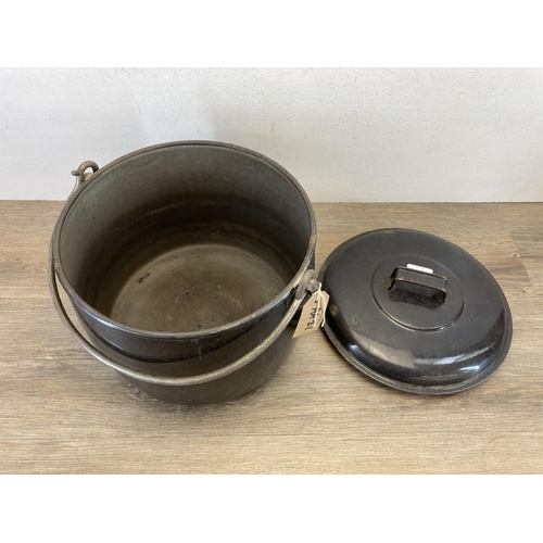 383 - A vintage black enamel cooking pot - approx. 28cm high