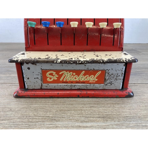 393 - Two mid 20th century toys, one piano and one St. Michael cash register - approx. 19cm high