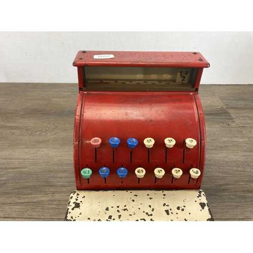 393 - Two mid 20th century toys, one piano and one St. Michael cash register - approx. 19cm high