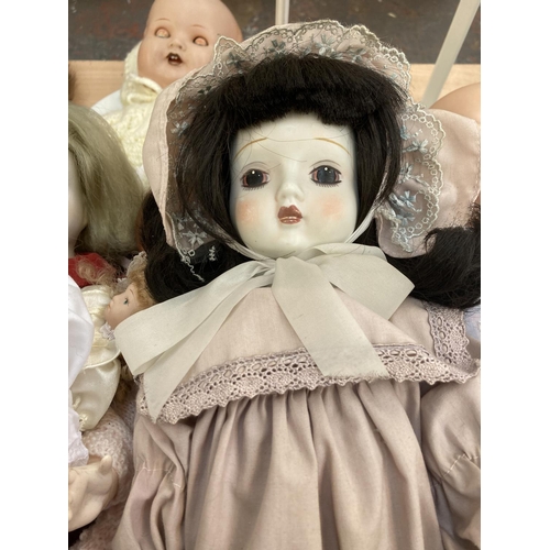 412 - A collection of porcelain and composition dolls to include Armand Marseille 518/5½K etc.