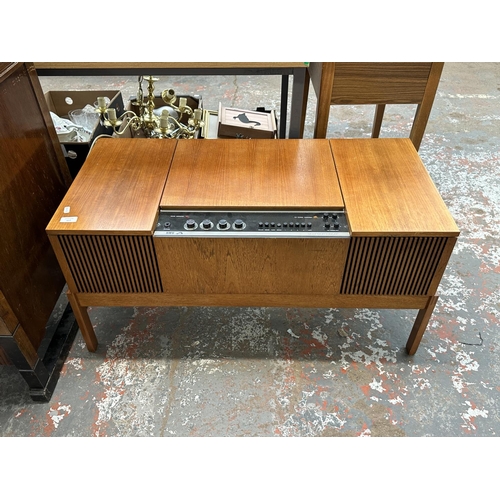 617 - A 1960s His Master's Voice Stereomaster 2419 radiogram comprising FM receiver and BSR C142R three-sp... 