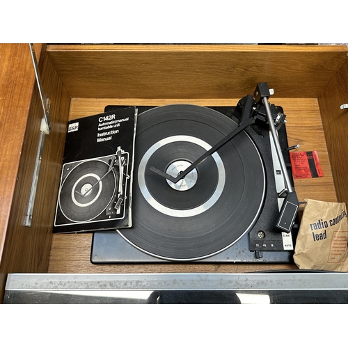 617 - A 1960s His Master's Voice Stereomaster 2419 radiogram comprising FM receiver and BSR C142R three-sp... 