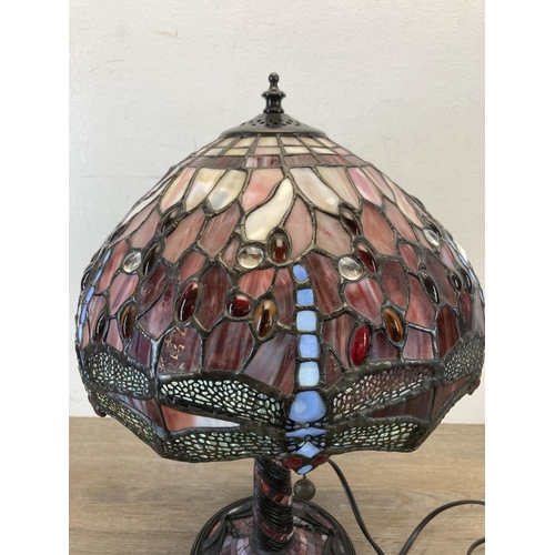 454 - A Tiffany style bronzed and stained glass dragonfly table lamp - approx. 46cm high