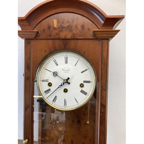 A Comitti of London yew wood cased chiming wall clock with pendulum and key approx. 67cm high