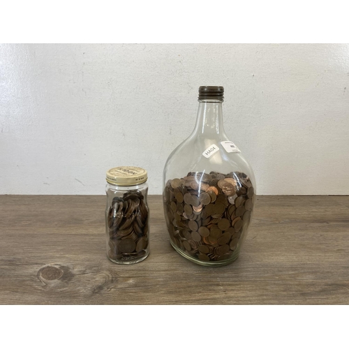 490 - Two glass jars, one containing a large quantity of decimal half pennies and one containing a large q... 