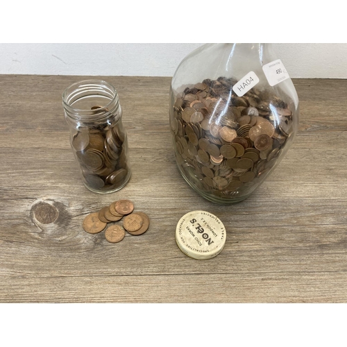 490 - Two glass jars, one containing a large quantity of decimal half pennies and one containing a large q... 