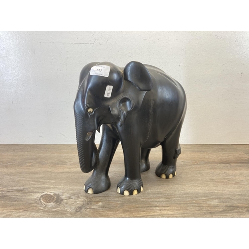 523 - A late 19th/early 20th century carved ebony elephant figurine - approx. 31cm high