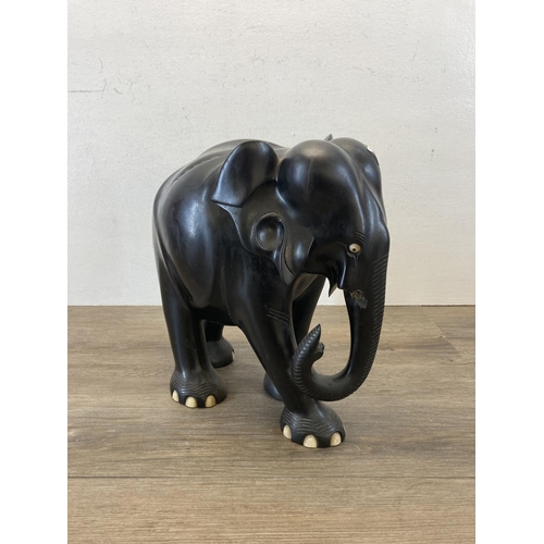 523 - A late 19th/early 20th century carved ebony elephant figurine - approx. 31cm high