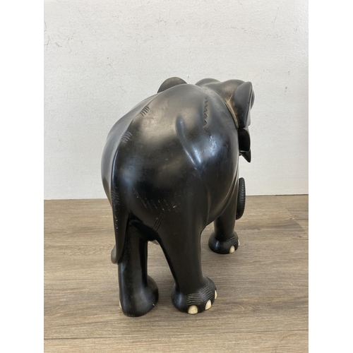 523 - A late 19th/early 20th century carved ebony elephant figurine - approx. 31cm high