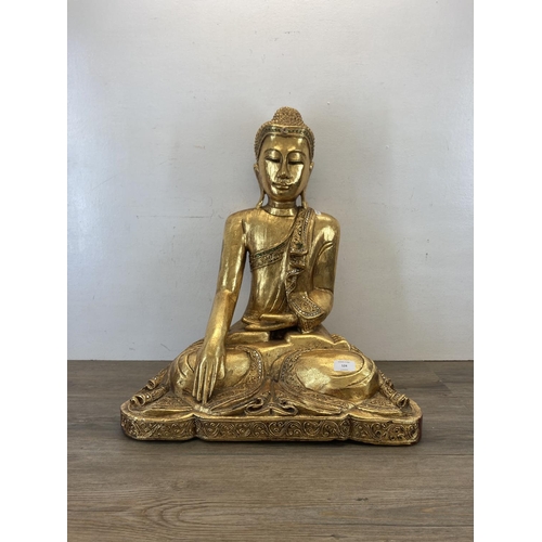 524 - A modern gilt plaster buddha statue - approx. 62cm high