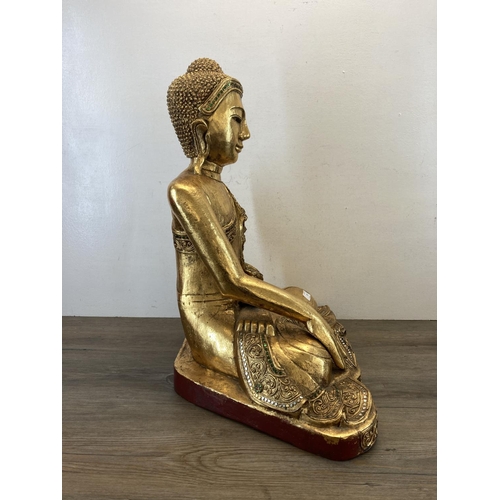 524 - A modern gilt plaster buddha statue - approx. 62cm high