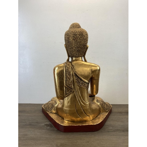 524 - A modern gilt plaster buddha statue - approx. 62cm high