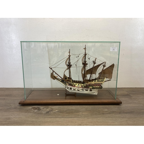 525 - A hand painted wooden model ship with glass case and oak plinth - approx. 35cm high x 20cm wide x 58... 