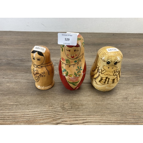 529 - Three Russian hand painted wooden nesting dolls - largest approx. 14cm high