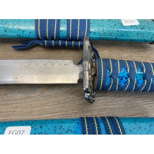 532 - A set of three ornamental katana swords - largest approx. 101cm long