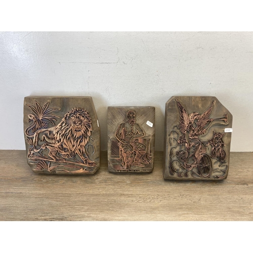 534 - Three carved wooden and copper printing block wall plaques - largest approx. 27cm high x 25cm wide