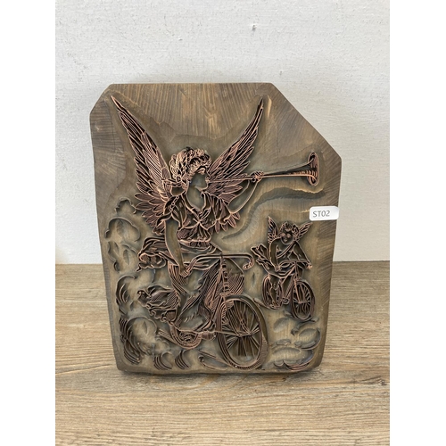 534 - Three carved wooden and copper printing block wall plaques - largest approx. 27cm high x 25cm wide