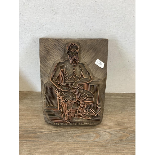 534 - Three carved wooden and copper printing block wall plaques - largest approx. 27cm high x 25cm wide