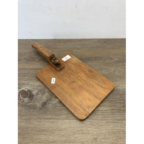 535 - A Bob 'Wren Man' Hunter carved oak cheeseboard - approx. 39cm long