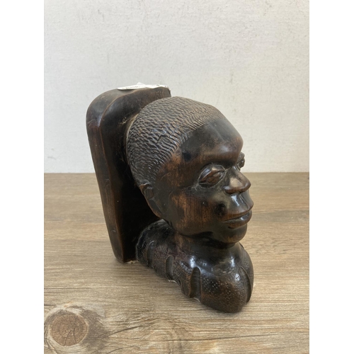 540 - An African carved hardwood bookend - approx. 18cm high