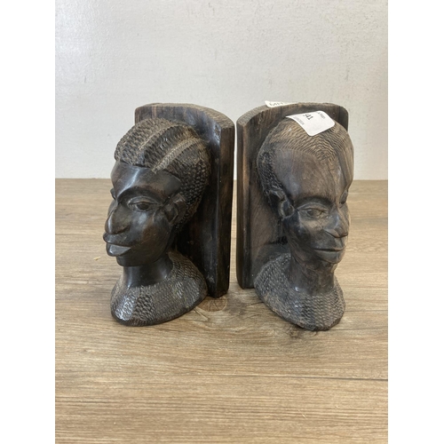 541 - A pair of African carved hardwood bookends - approx. 17cm high