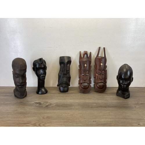 542 - Six African carved hardwood items, three busts and three wall masks - largest approx. 30cm high