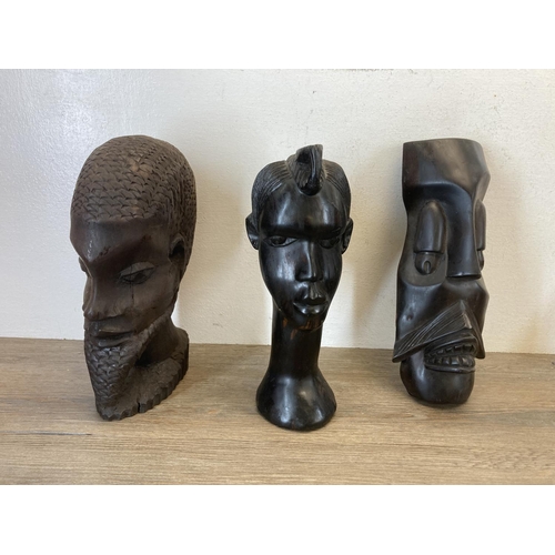 542 - Six African carved hardwood items, three busts and three wall masks - largest approx. 30cm high