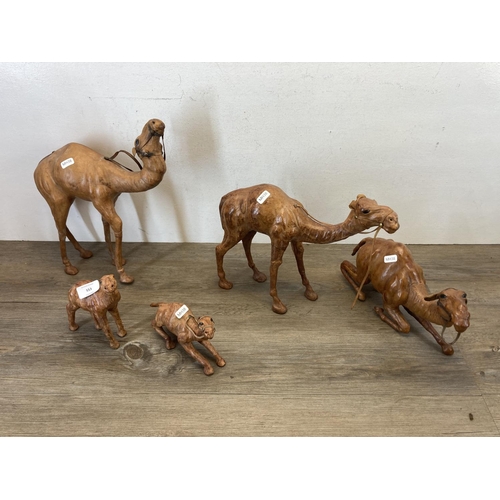 553 - Five Liberty style leather model camels - largest approx. 35cm high