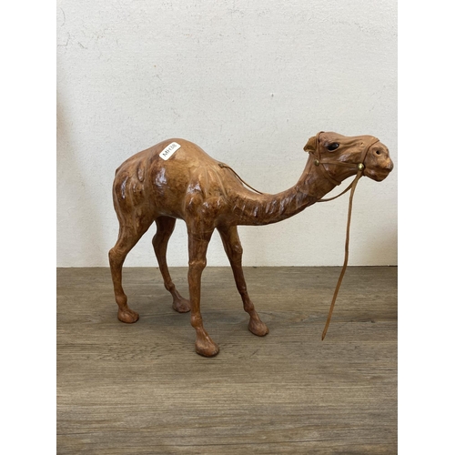 553 - Five Liberty style leather model camels - largest approx. 35cm high