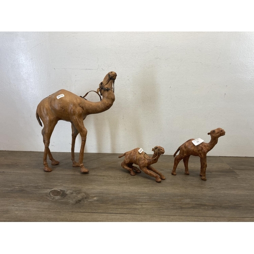 553 - Five Liberty style leather model camels - largest approx. 35cm high