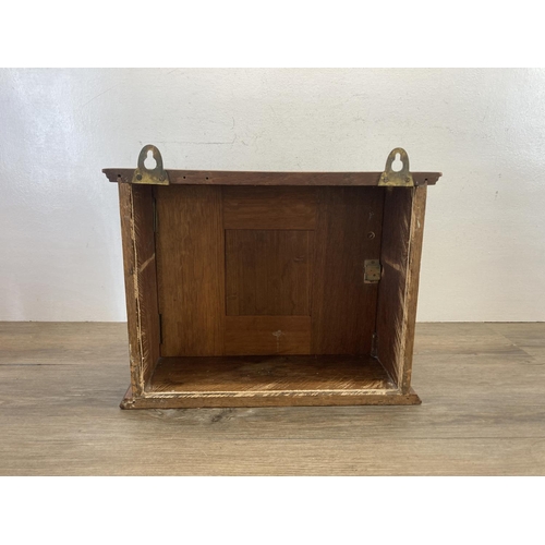 555 - An early/mid 20th century carved oak wall mountable cabinet - approx. 31cm high x 41cm wide x 17cm d... 