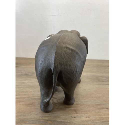 557 - A carved hardwood elephant figurine - approx. 28cm high