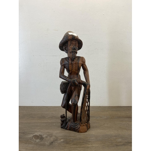 561 - An Oriental carved hardwood fisherman figurine - approx. 50cm high