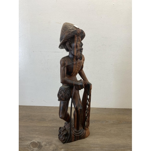 561 - An Oriental carved hardwood fisherman figurine - approx. 50cm high