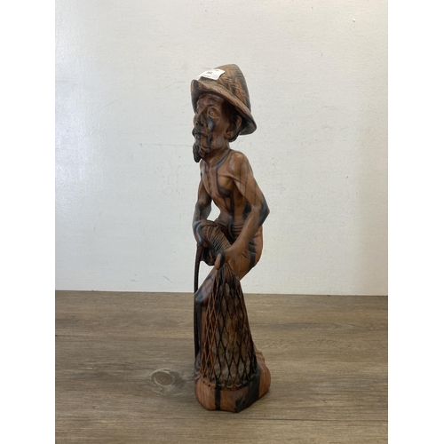 561 - An Oriental carved hardwood fisherman figurine - approx. 50cm high