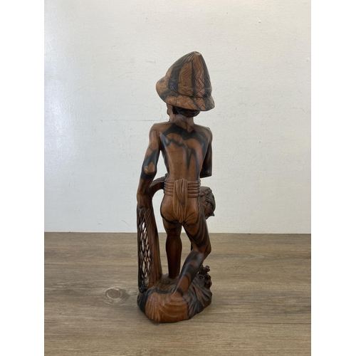 561 - An Oriental carved hardwood fisherman figurine - approx. 50cm high