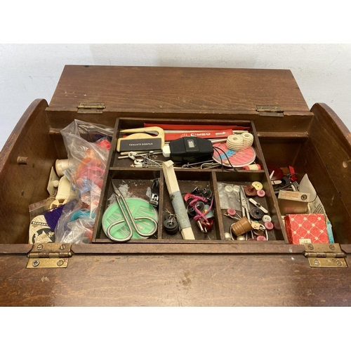 562 - A mid 20th century beech sewing box with contents - approx. 46cm high x 27cm wide x 46cm deep