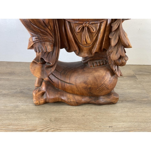 563 - An Oriental carved hardwood laughing buddha statue - approx. 82cm high