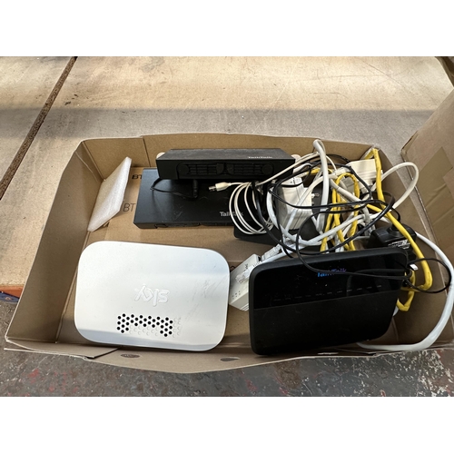 832 - Two boxes containing landline phones and Wi-Fi hubs